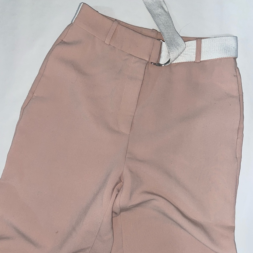 High-waisted peach-colored trousers